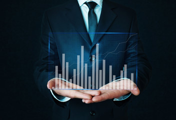 Businessman holding graph. Finance concept.