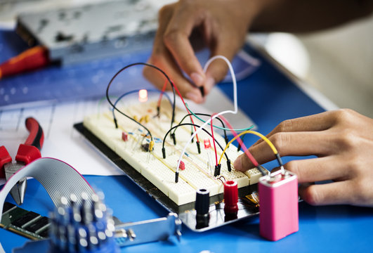 Closeup of hands working on breadboard