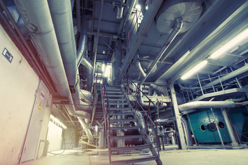 Equipment, cables and piping as found inside of a modern industrial power plant