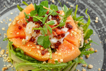 Citrus green salad with salmon, grapefruit and avocado.