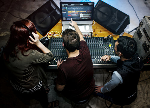 People at a sound mixer station