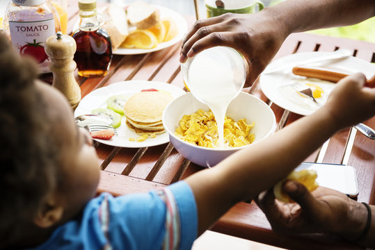 Black family having breakfast together