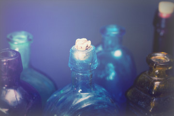 Old colourful bottles against a dark background