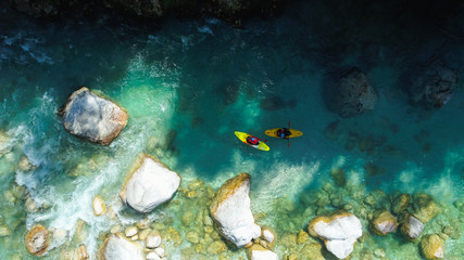 Fototapeta na wymiar Whitewater Rafting on the Emerald waters of Soca river, Slovenia, are the rafting paradise for adrenaline seekers and also nature lovers, aerial view.