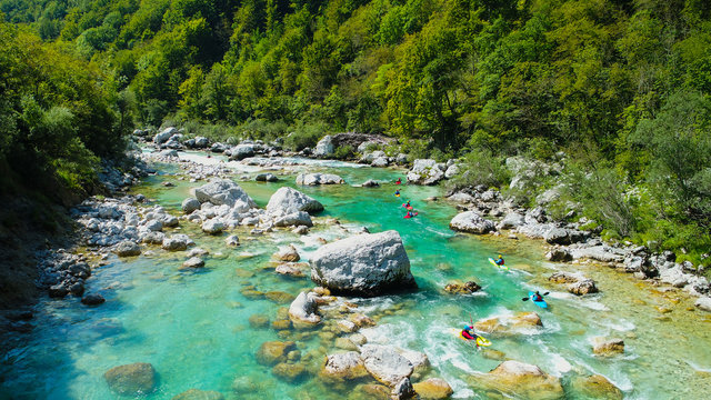 Emerald waters of Soca river, Slovenia, are the rafting paradise for adrenaline seekers and also nature lovers, aerial view.