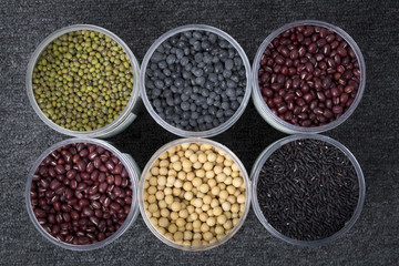 The ranks of different beans: soybean,  mung bean, bean, black bean. And black  rice. View from above.
