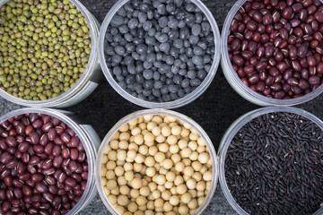 The ranks of different beans: soybean,  mung bean, bean, black bean. And black  rice. View from above.
