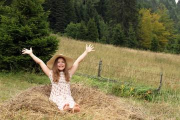 Naklejka na ściany i meble beautiful little girl with hands up enjoys nature