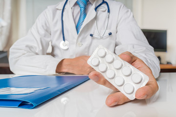 Doctor is giving painkiller pills to a patient.