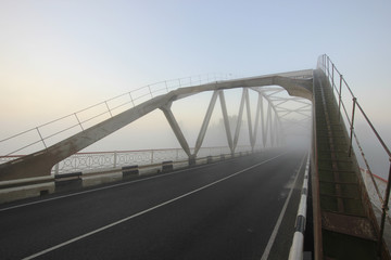 bridge in fog at sunrise