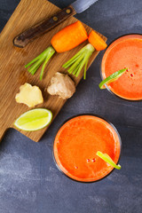 Carrot, ginger and lime smoothie. View from above, top studio shot