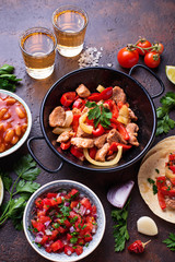Concept of Mexican food.  Salsa, tortilla, beans, fajitas and tequila