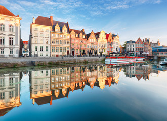 Gent, Belgium. Sunrise in historical center of Ghent reflecting in water of river Leie Flanders,...
