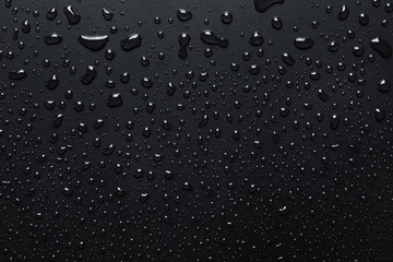 Water drops on rough surface, dark background