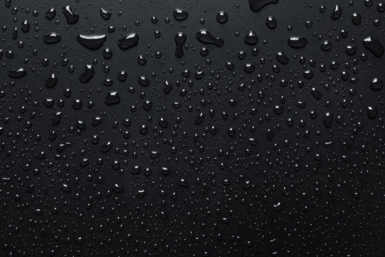 Water drops on rough surface, dark background