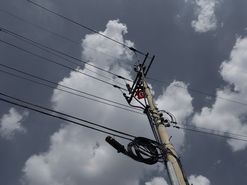 telegraph pole and grey sky with clouds