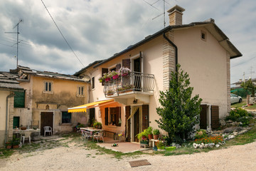 Fototapeta na wymiar Cescatto, Italy - August 22, 2017: House with patio from the mountain village of Italy.
