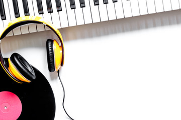 songwriter or dj work place with synthesizer, vinyl record and headphones on white background top...