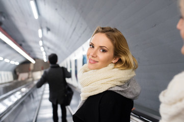 Young woman standing at the escalator in Vienna subway