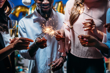 friends celebrating new year with sparklers