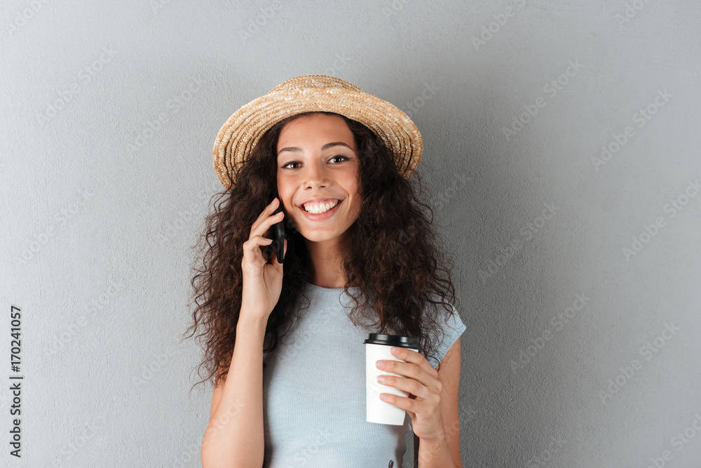 Sticker beauty smiling curly woman in hat talking by the smartphone