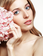 Naklejka na ściany i meble Closeup portrait of young beauty female face with blond hair and hydrangea bouquet flowers