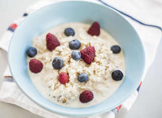 Healthy breakfast - oatmeal with blueberries and raspberries