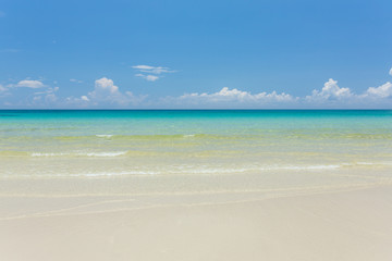 Fototapeta na wymiar Tropical white sand beach with turquoise water under blue sky. Paradise background