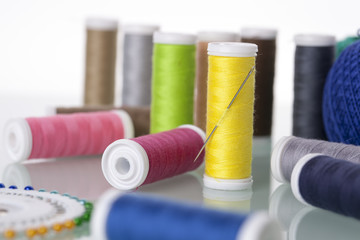 Sewing equipment and  threads on white background.