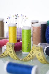 Sewing equipment and  threads on white background.