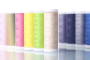 Sewing equipment and  threads on white background.