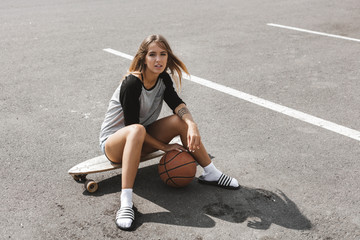 Girl sits on longboard