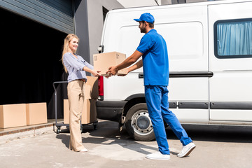 courier giving package to woman