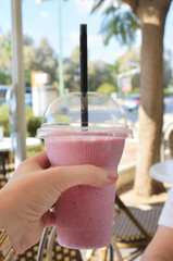 a glass of fresh smoothy drink in street cafe