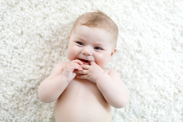 Adorable naked baby girl on white background. © Irina Schmidt