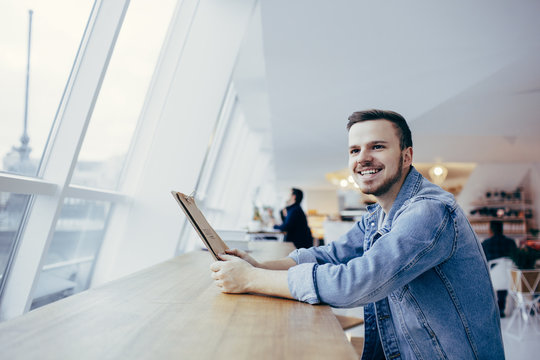 Happy young student has time break