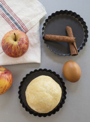 Apple pie ingredients. Dough, apple slices and almonds.