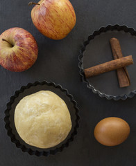Apple pie ingredients. Dough, apple slices and almonds.