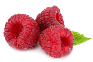 ripe raspberries with green leaf isolated on white background macro