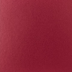 Background texture of a shiny metal sheet with a rough stippled textured surface reflecting light. Metal texture