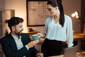 Positive female person giving cup