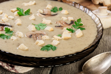 Mushroom cream soup with croutons and spices