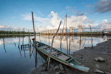 Architecture building beautiful Utho Wipat prasit floodgates with wooden boat on coast