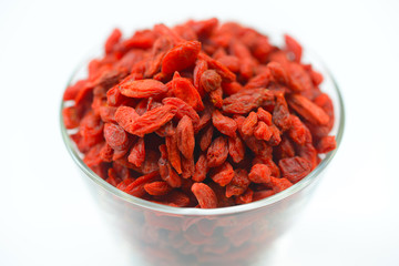 Chinese goji berries in bowl close up on white background