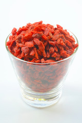 Chinese goji berries in bowl close up on white background