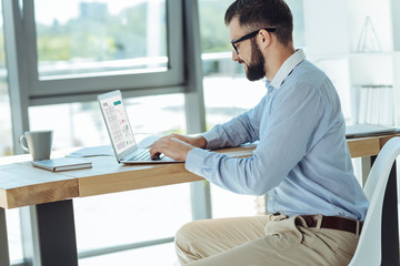 Young bearded man working on his new research