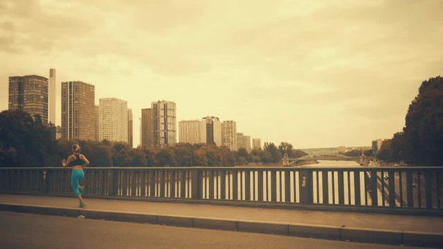 Woman running. Morning runner on the street with beautiful city view in Paris under sunlight