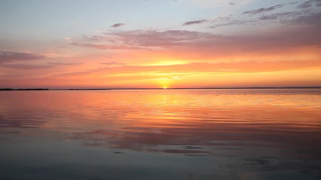 Ocean wave water surface with rising sun reflection. Florida, USA