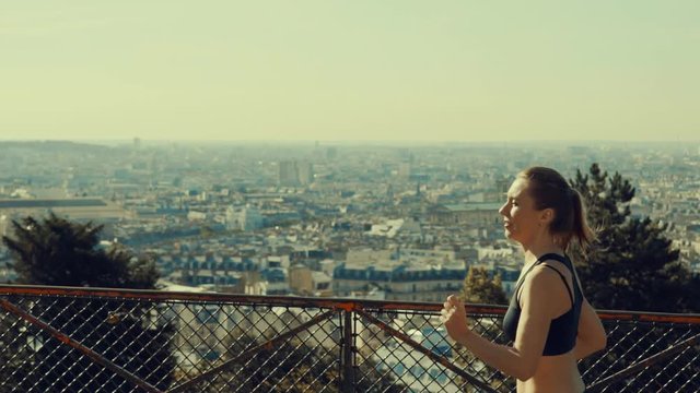 Woman running. Morning runner on the street with beautiful city view in Paris under sunlight.