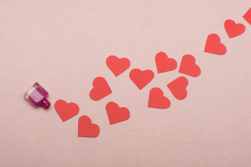 Path of paper hearts on light pink background, top view